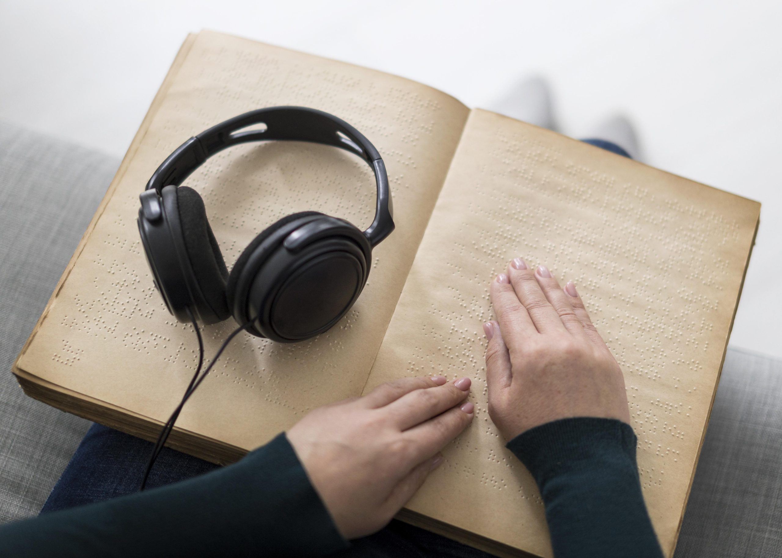 close-up-hands-touching-braille-book